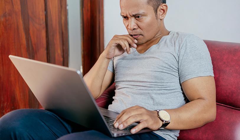 Image of a man working on his laptop