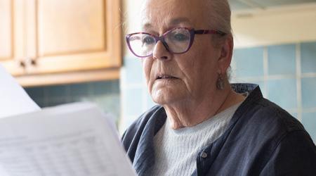 A woman examines some paperwork. 